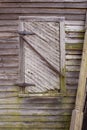 Old greying bare wood siding and window