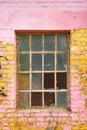 Old grid windows with broken glass on exterior wall of an old abandoned factory Royalty Free Stock Photo