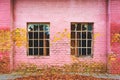 Old grid windows with broken glass on exterior wall Royalty Free Stock Photo