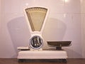 Old grocer`s scales on a white tiled wall Royalty Free Stock Photo