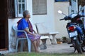 Old grown woman retired. Asian woman alone. The pensive pensioner on the bench.