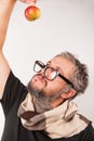 Old grumpy man with beard and big nerd glasses and an apple Royalty Free Stock Photo