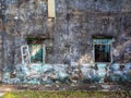 Old grunge concrete wall of abandoned building with decayed windows Royalty Free Stock Photo