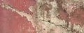 Old grunge cracked vintage concrete and cement mold texture wall background with pink weathered paint and scratches. Royalty Free Stock Photo