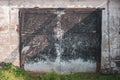 Old grunge garage door with black iron doors Royalty Free Stock Photo