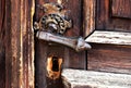 old grunge pine wood door with worn cast iron door handle Royalty Free Stock Photo