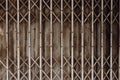 Old grunge rusty shutter folding door for shop closed or business down concept, texture pattern or steel gate