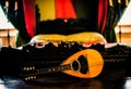 Old grunge vintage mandolin on wooden wall in a historical room