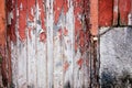 Old grunge and weathered red and white wooden locked door with rusty chain