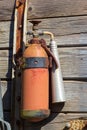 old and grunge wooden wall mounted fire extinguisher background and texture Royalty Free Stock Photo