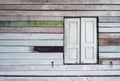 Old grunged wooden window frame painted white vintage with old colourful plywood wall. Antique window frame and old panes. Old Royalty Free Stock Photo
