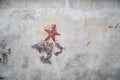 Communistic symbol: Grungy red star graffiti on and old wall Royalty Free Stock Photo