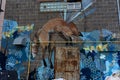 Old grungy wall with a rusty door, painted fox and colorful street art