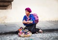 Old guatamalian woman salling traditional goods at the street in