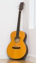 Old guitar laying on the wooden floor.