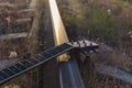 Old guitar lying on the rails