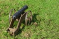 Old Gun In The Green Grass. The Weapon Is An Old Cannon. Medieval Historical Installation