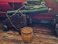 Old gun and powder keg on the deck of a wooden sailing ship