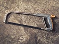 Old hacksaw on concrete grungy background Royalty Free Stock Photo