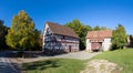 old half timbered farm house with barn in Hessenpark. Since 1974, more than 100 endangered buildings have been re-erected at the Royalty Free Stock Photo