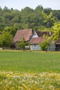 Old half-timbered farm houses with forest and agricultural fields Royalty Free Stock Photo