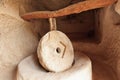 Old stone millstones in one of the ancient caves of the red valley of Cappadocia