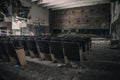 An old hall with seating in an abandoned cinema.