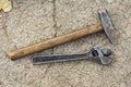 Old hammer and adjustable spanner lying on the pavement Royalty Free Stock Photo