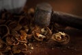 Old hammer with dark aged metal cheek of hammer and scratched polished wood handle closeup. Vintage hammer used as nutcracker with