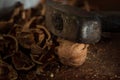 Old hammer with dark aged metal cheek of hammer and scratched polished wood handle closeup. Vintage hammer used as nutcracker with