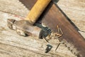 Old hammer and and saw on wooden table Royalty Free Stock Photo