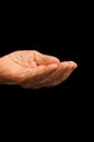 The old hand begging on the black Royalty Free Stock Photo