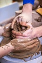 Old Hand Experienced Male Potter Working with Female Apprentice. Working with Clay Lump on Potter`s Wheel in Workshop Royalty Free Stock Photo