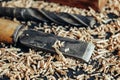 Old hand plane, drill and chisel with wooden shavings on black background. Old woodworking hand tool. Copy, empty space for text Royalty Free Stock Photo