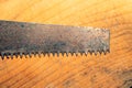 Old hand saw on a dirty wooden background. working area with hand instrument. carpentry tool. manual labor concept Royalty Free Stock Photo