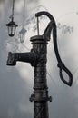 Old hand water pump and a lantern Royalty Free Stock Photo