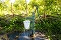 Old hand water pump outside in the garden Royalty Free Stock Photo