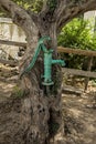 Old hand water pump on a well in the garden, watering and saving water in Austria. Royalty Free Stock Photo