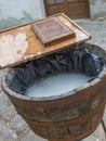 Old handcraft papermaking process with water, bucket and wooden sieve Royalty Free Stock Photo