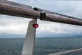 Old handrail against north sea with lock in form of heart Royalty Free Stock Photo