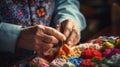 Close up of wrinkled tired fingers and hands doing knitting. Handmade skills.