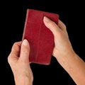 Old hands (woman) holding a very old bible Royalty Free Stock Photo