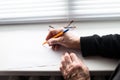 Old hands writing on piece of paper. The hands of an elderly woman are writing Royalty Free Stock Photo