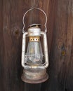 Old hanging kerosene lantern on wall.