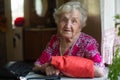 Old happy lady portrait with a handbag at a table Royalty Free Stock Photo