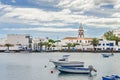 Old harbor of Arrecife with boats and the sixteenth century catholic church San Gines de Clermont