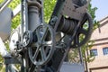 Harbor old crane hoist gearing metal in gray.