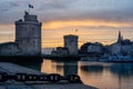 The old harbor of La Rochelle at sunset with its famous old towers. beautiful orange sky