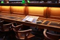 old hard cover book sitting at an old traditional timber reading desk under a glass lamp in an old state library in Melbourne, Royalty Free Stock Photo