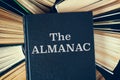 Old hardcover books with book The Almanac on top